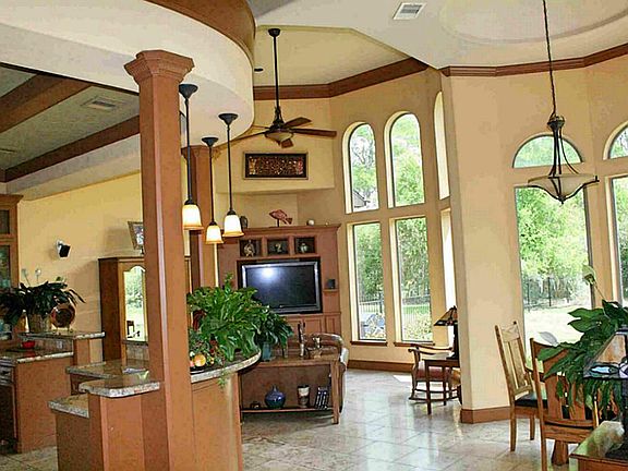 Grotto style kitchen, den and breakfast area combine to showcase the open floor plan, vaulted ceilings and abundant natural light