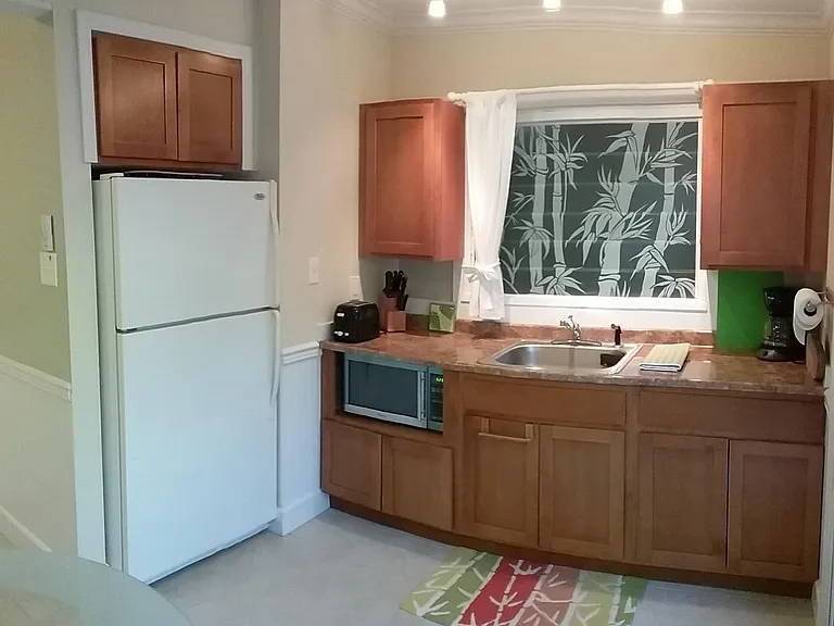 Eat-in kitchen with full fridge. Kitchen comes fully stocked.