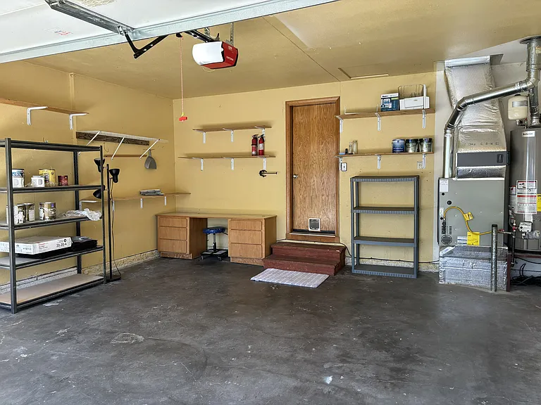 Two car garage with shelving and workbenches