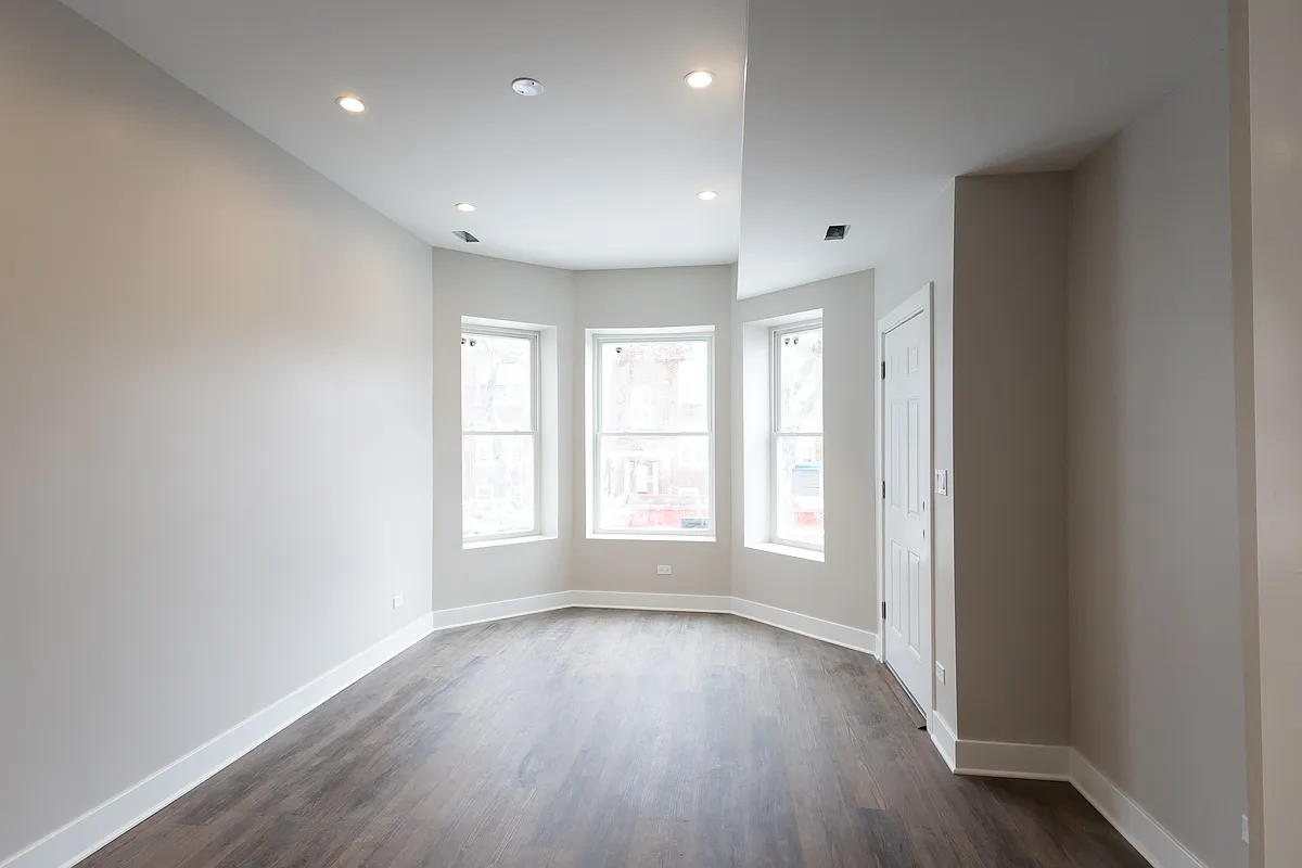 The living room has amazing light and has a dedicated TV nook that is ready for any internet or cable service provider. - 3942 W Cornelia Ave #2
