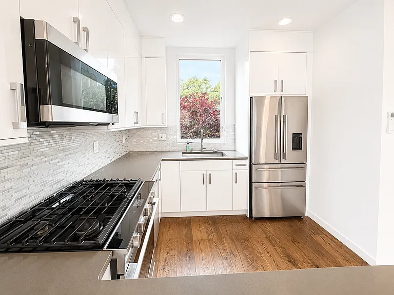 Contemporary kitchen with stainless steel appliances.