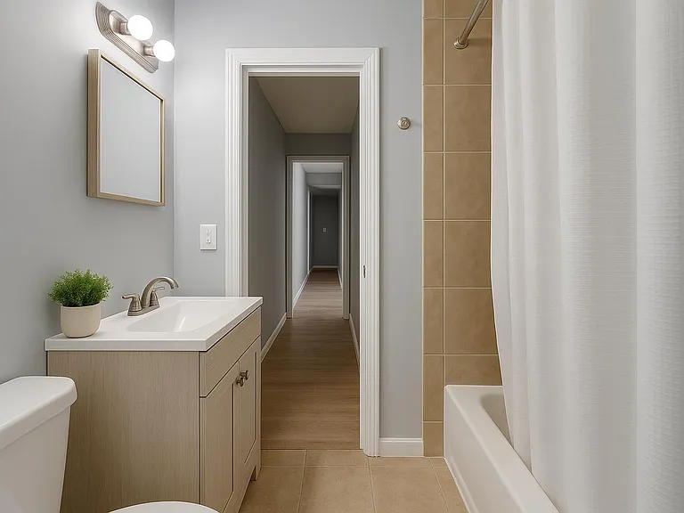Well-kept shared bathroom with modern shower, clean tile, and an easy daily routin