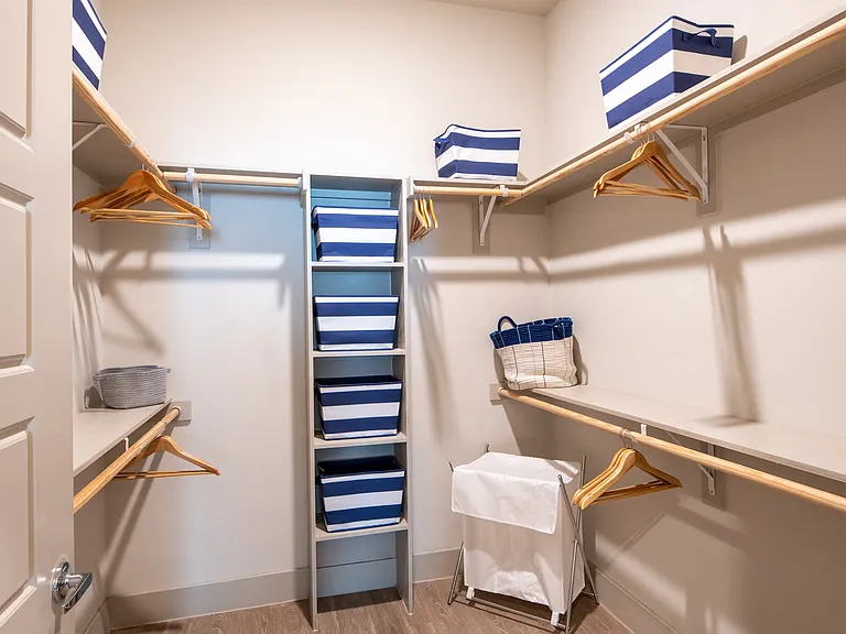 Spacious Walk-In Closet with Built-In Shelving and Ample Hanging Space