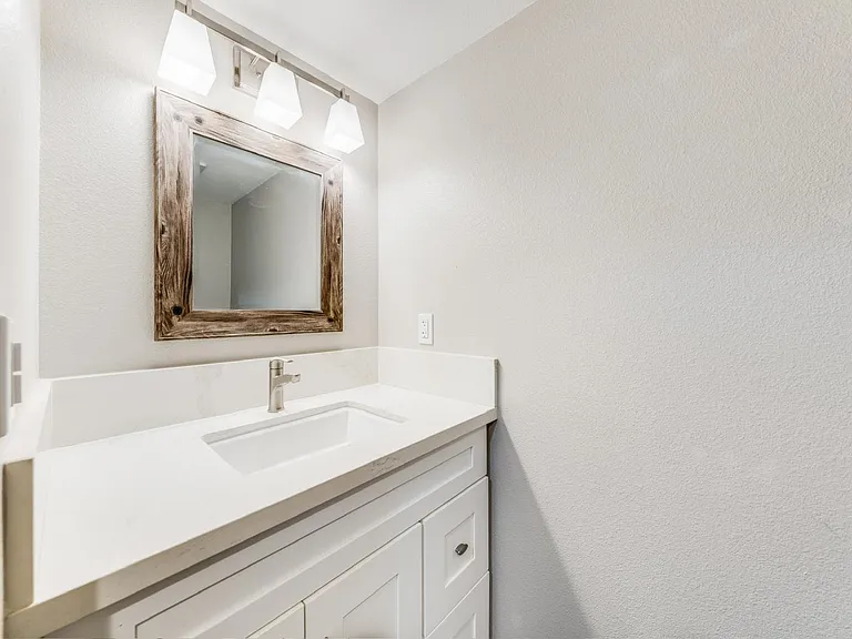 Dedicated laundry area with full-size washer and dryer, utility sink, and half bathroom on first floor for everyday convenience.