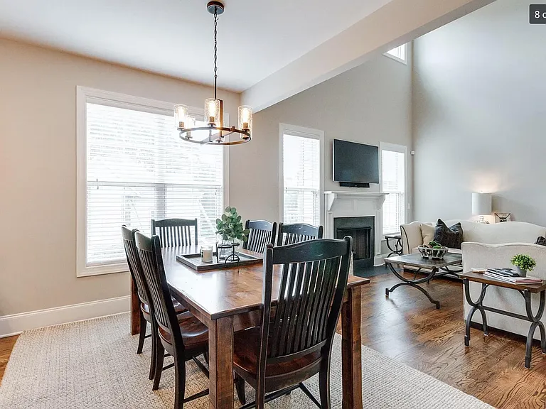 Open concept dining area leading from kitchen to living area