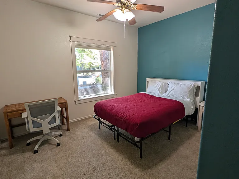 Second bedroom with desk, and window that looks onto the front yard