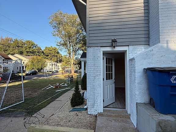 Separate side entrance leading to the main apartment with living area, kitchen, and bedrooms."