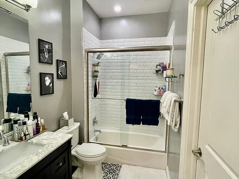 Bathroom w/ Designer Tile and Large Vanity w/ Drawers and Doors.