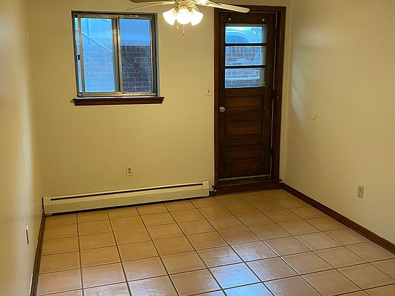 Dining area of kitchen with back door leading to back yard.