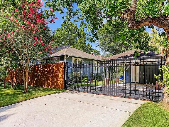 Corner lot offers gated double drive entry.