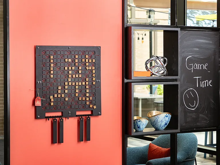 Wall-Mounted Word Game Board and Chalk Art Decor in Community Lounge