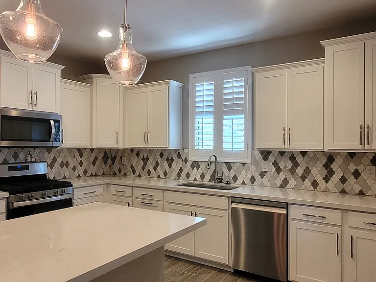 Pretty backsplash and beautiful pendant lights