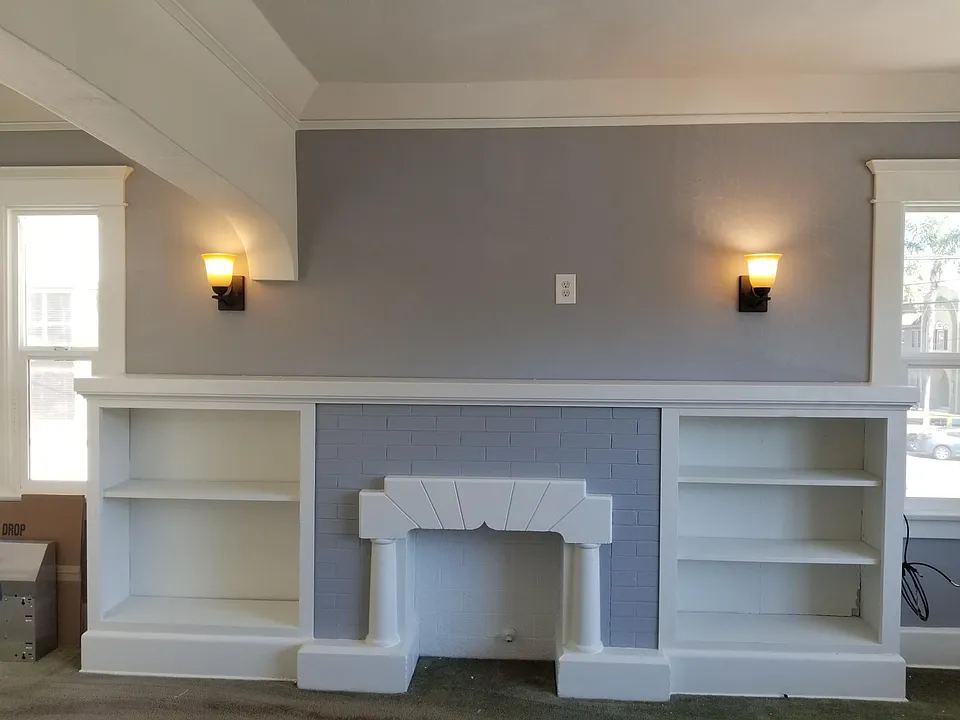 View of the living room built-in with faux fire place, outlet on the wall is perfect for your large screen TV.