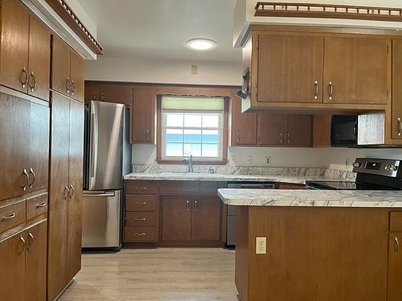 Brand new counter-tops, porcelain sink and faucet. Lots of cabinets and brand new stainless steel electric smooth top range.