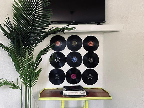Large TV wall with vintage records