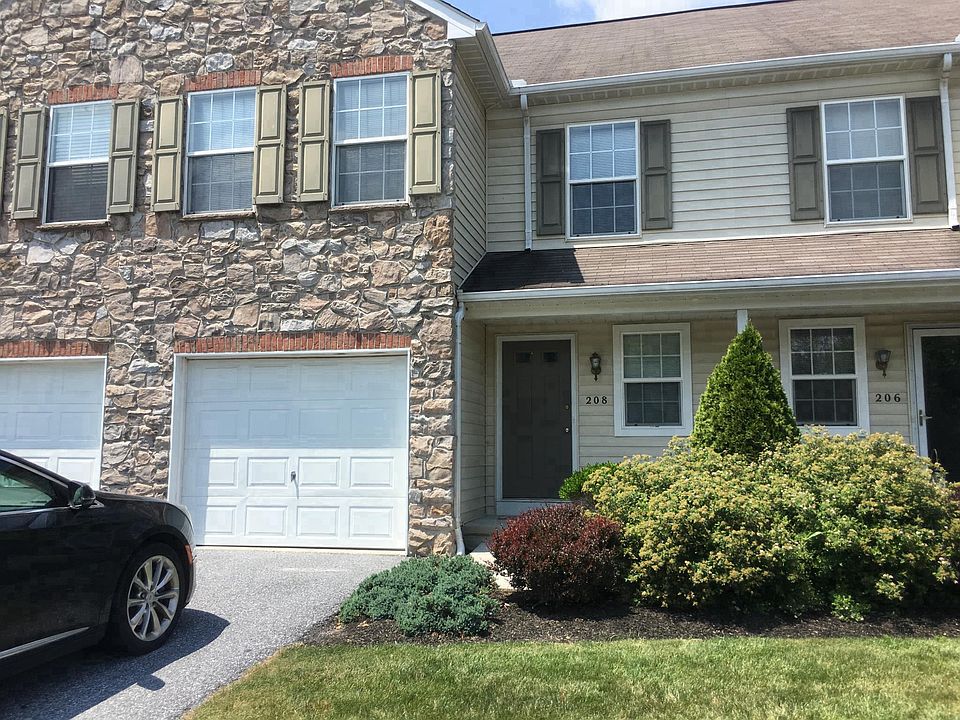 Beautiful landscaping with a one car garage and private park