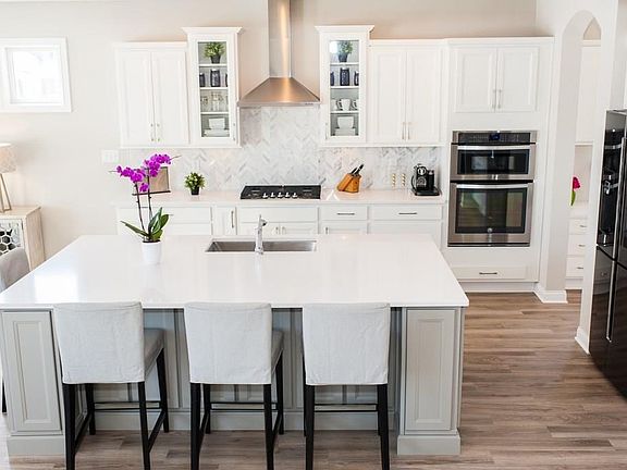 Large open kitchen with herringbone marble backsplash