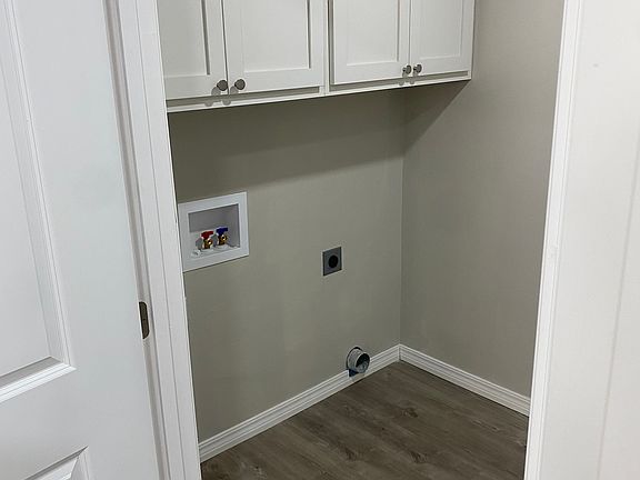 Laundry room set up, washer and drying not included. Cabinet storage and backyard exit door.