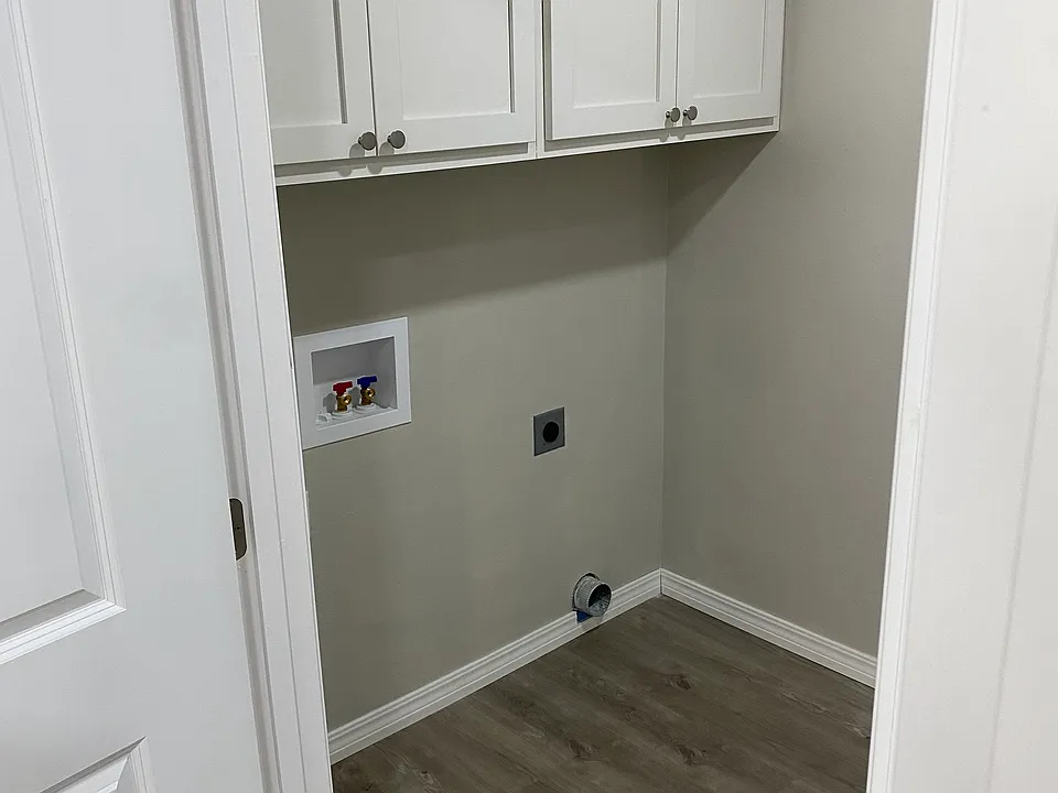Laundry room set up, washer and drying not included. Cabinet storage and backyard exit door.