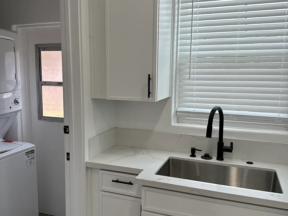 Small storage with new washer and dryer and back door