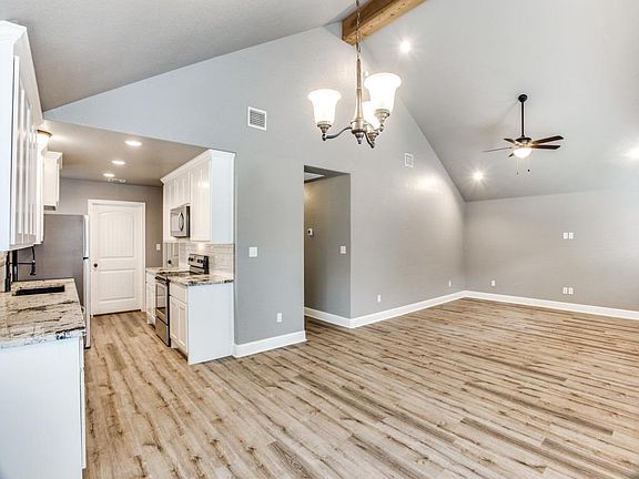 Open Concept Living/ Dining/ High Ceilings with recessed lighting and ceiling fan in Living room.