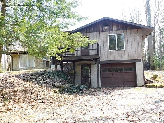 SIDE OF HOUSE HAS EXTRA GARAGE DOOR AND STORAGE