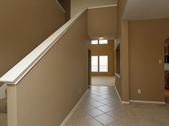 AS YOU ENTER THE HOME, THE STAIRS GO UP TO 3 BEDROOMS AND A GAME ROOM.