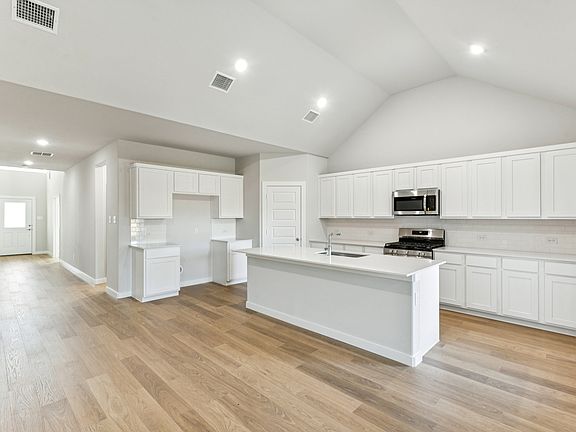 Kitchen in the Wimbledon home plan by Trophy Signature Homes - REPRESENTATIVE PHOTO