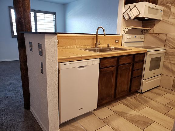 Small but efficient, fully equipped kitchen with built-in appliances (including built-in microwave) which opens onto the living / dining area.