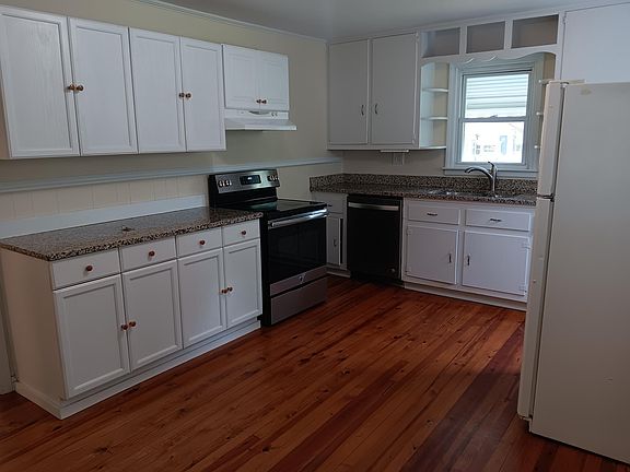 kitchen with dishwasher, fridge, range and microwave. Nice countertops