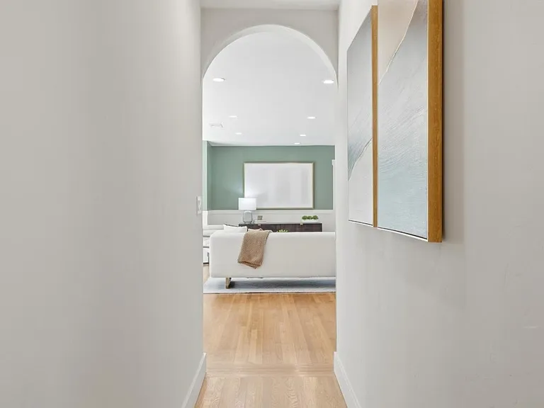 Bright hallway connecting private bedroom wing