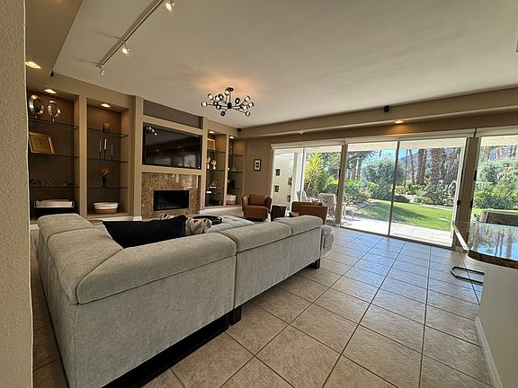 living room with beautiful mountain views, ample seating and large screen smart tv; inflatable king mattress fits well in this room for extra sleeping options