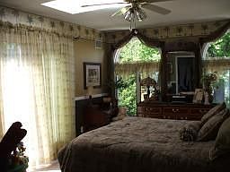 Master BR w/sliders to balcony.  Skylight above