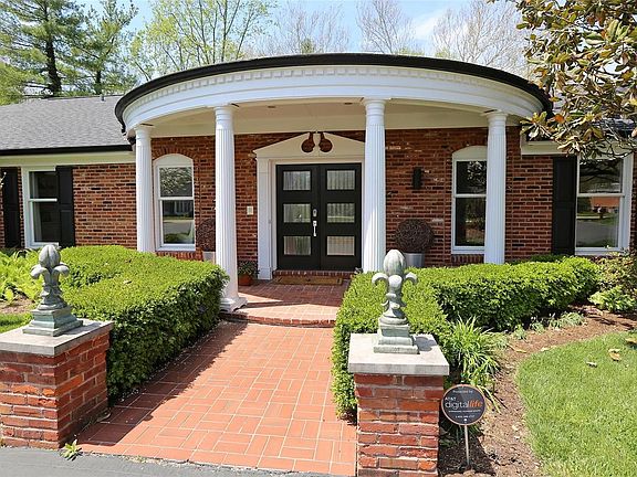 A closer look at the newer front door & covered front porch-Fleur de Lis statuary stays with home.