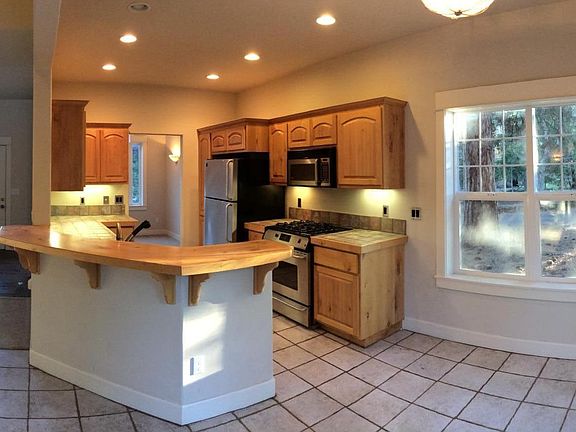 Panorama view of kitchen and entry.