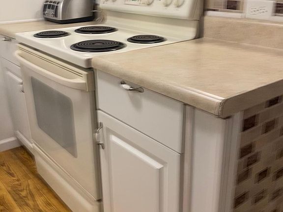 Other view of the kitchen showing the stove.