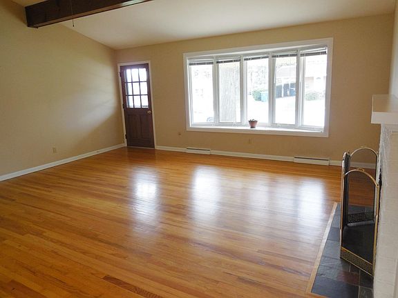Living room w/ large bay window & like new hardwood floors