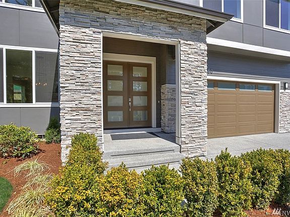 Covered porch. 3-car finished garage.