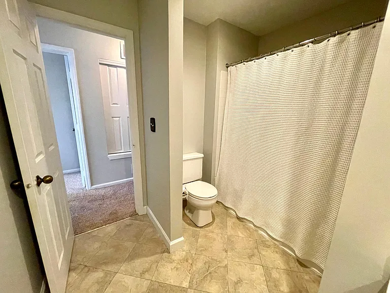 Main bathroom features a large counter with plenty of storage, a toilet, and a bathtub/shower combination with excellent water pressure.