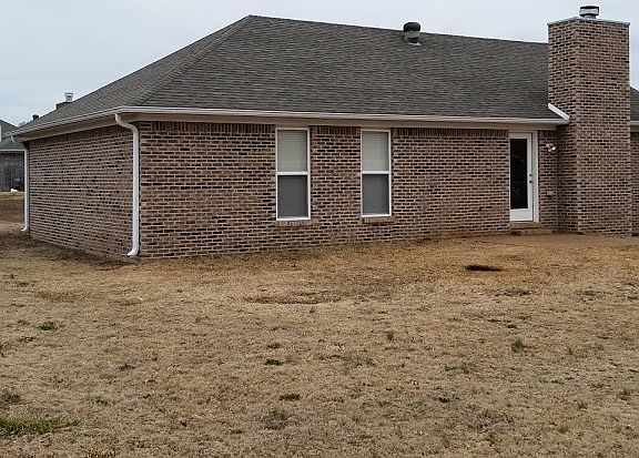 Side of house with lighted patio