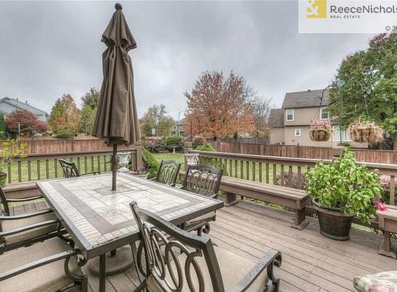 Enomous deck with bench seating and level fenced backyard makes for hours of fun.