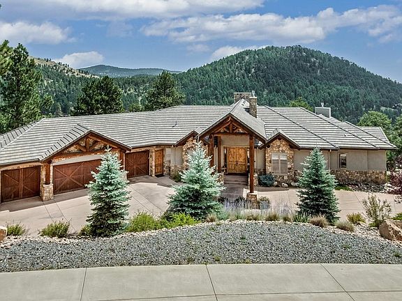 Stucco, stone and timbers adorn the home.