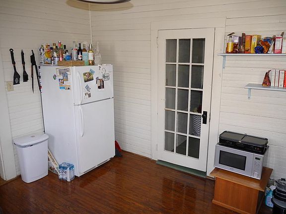 Kitchen with glass door leading to adjacent laundry/utility room.