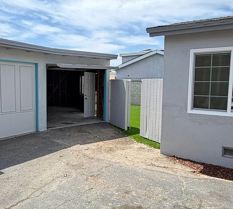 Detached garage and gate leading to backyard