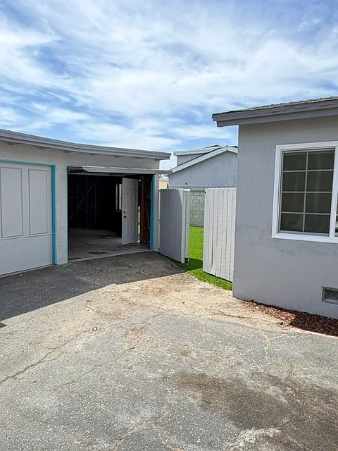 Detached garage and gate leading to backyard