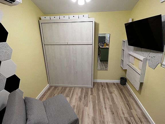 Living area displaying Murphy bed in upright position
