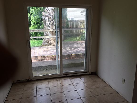 A backyard with a vast amount of space for activities and a