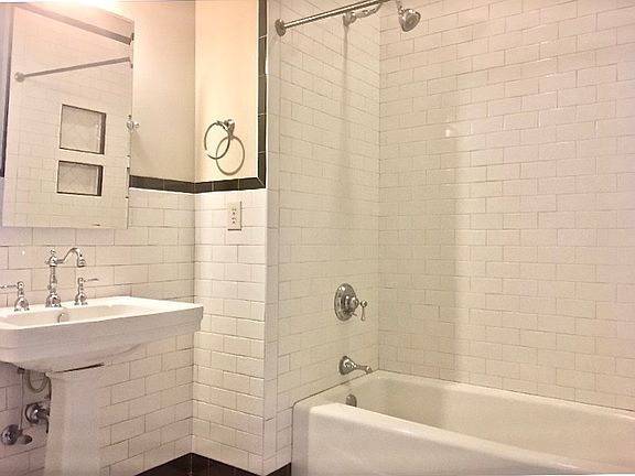Subway tile roomy bath with storage