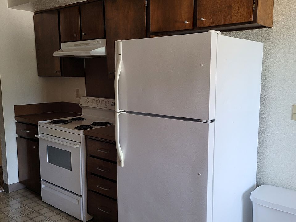 Kitchen with electric stove and refrigerator