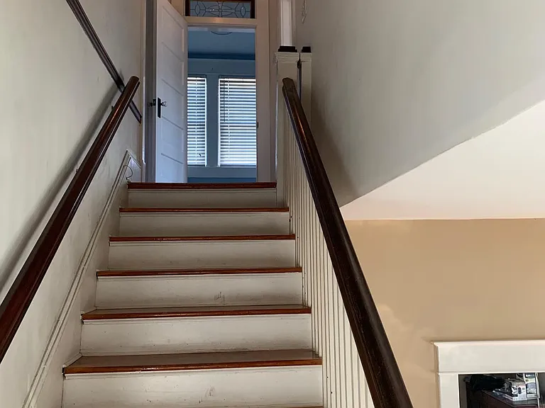 Stairs from main level foyer to top floor